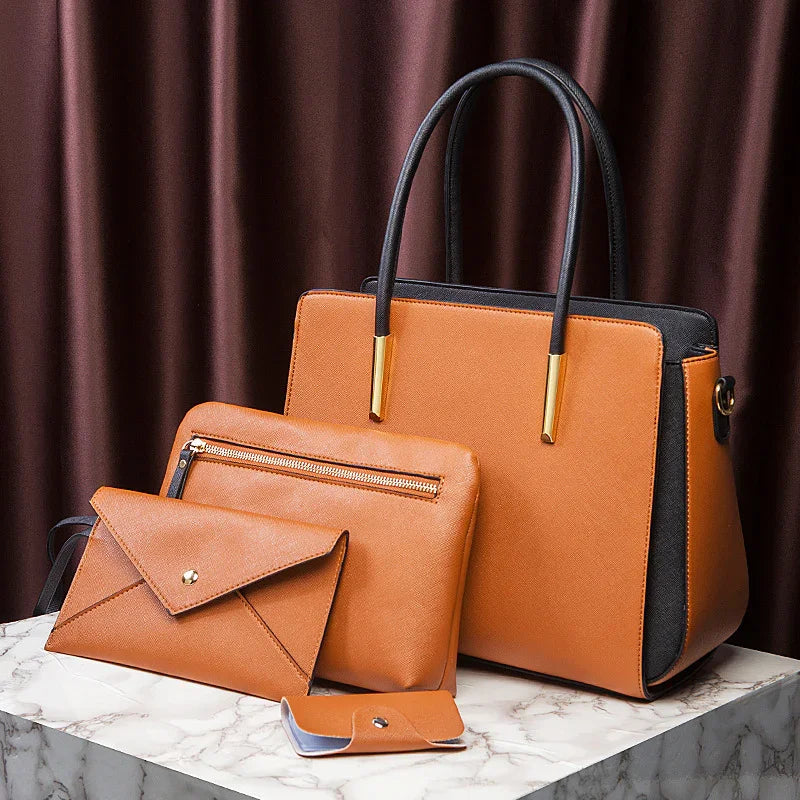 Set of tan and black leather handbags and wallets on a marble surface with brown curtain backdrop