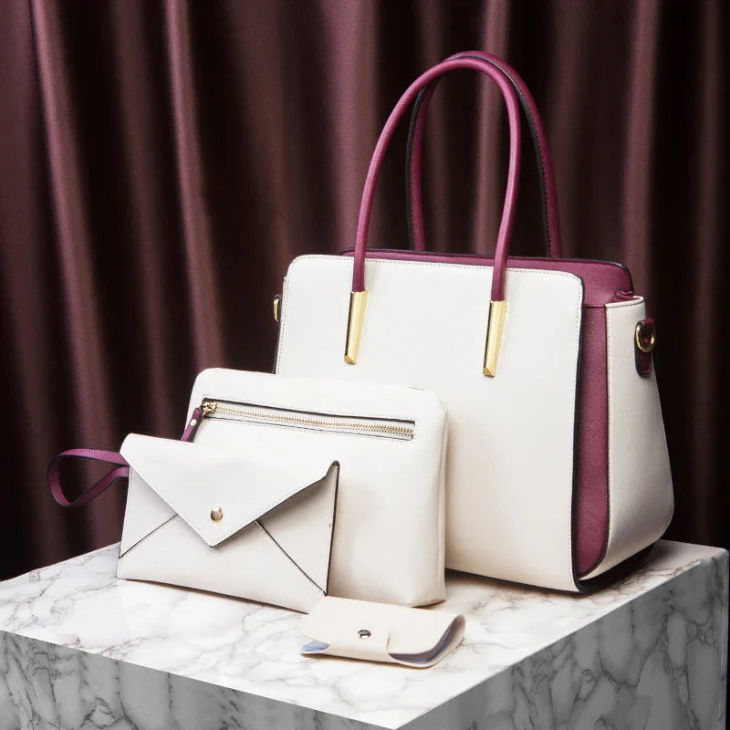 White and purple leather handbag set with gold accents on marble surface against brown curtain