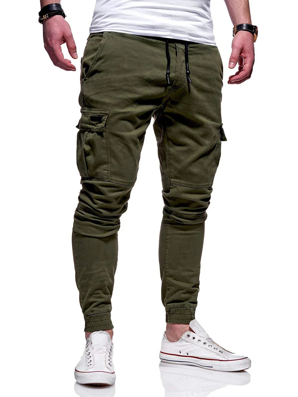 Man wearing olive green slim cargo jogger pants with elastic cuffs and white casual sneakers