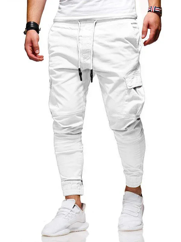 Man wearing white cargo jogger pants with drawstring waist and white sneakers