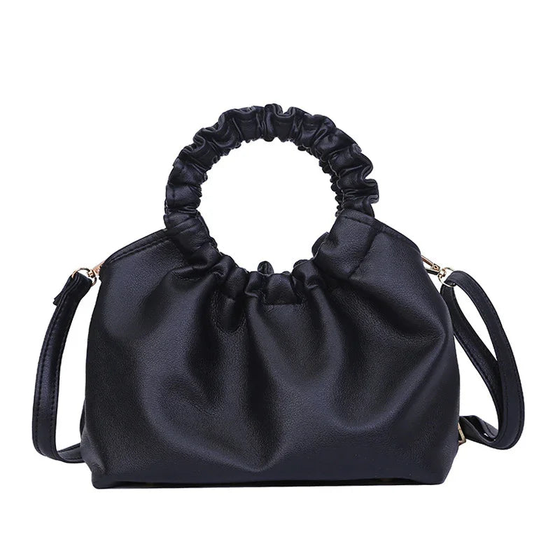 Black ruched leather handbag with round scrunched handle and detachable shoulder strap