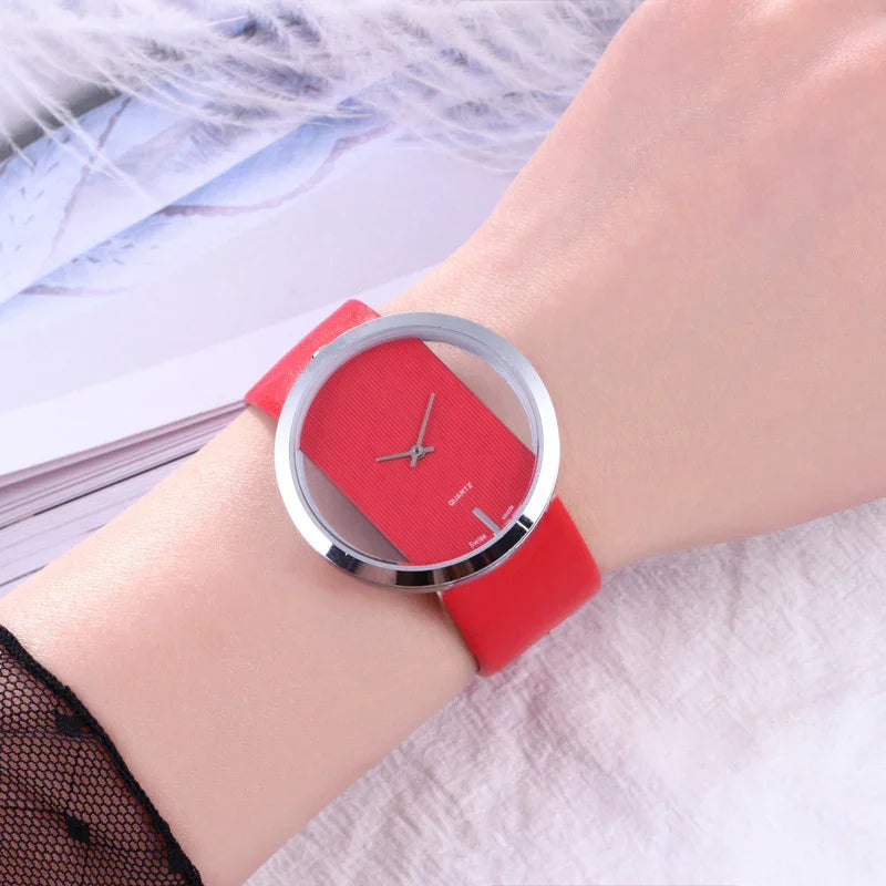 Modern red quartz wristwatch with transparent dial and silver bezel on wrist