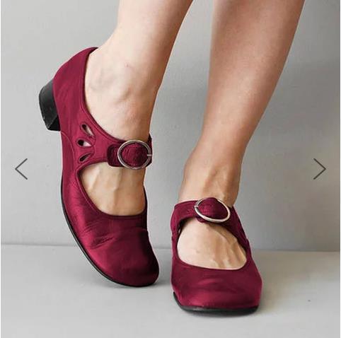 Pair of women's burgundy Mary Jane shoes with round buckle and low heel