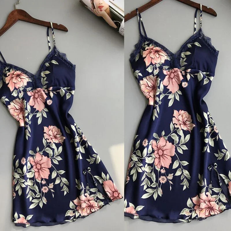 Navy blue satin slip dress with pink floral print and lace trim on wooden hanger