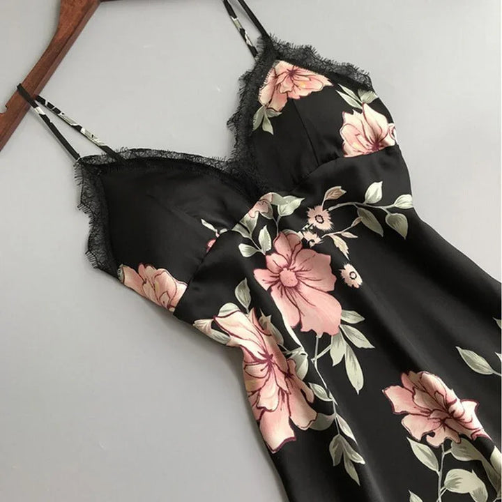 Black satin floral slip dress with pink flowers and delicate lace trim on straps