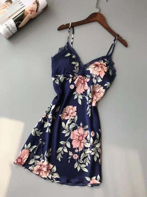 Navy blue floral satin slip dress with pink flowers and lace trim on wooden hanger