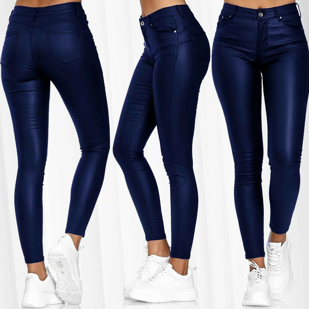 Three views of slim fit women's dark blue coated skinny jeans paired with white sneakers on neutral background