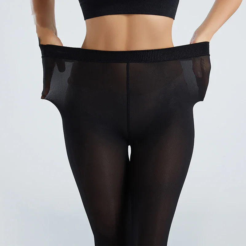 Close-up of woman wearing black sheer tights, stretching waistband to show elasticity