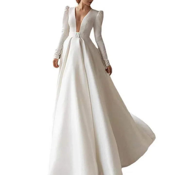 Elegant white long-sleeve wedding dress with deep V-neck and belted waist