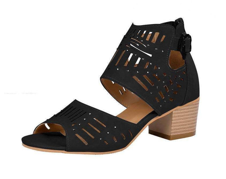 Black open-toe block heel sandal with geometric cutouts and ankle strap buckle