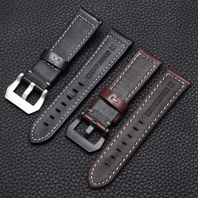 Black and brown genuine leather watch straps with stitching and metal buckles on a textured black surface
