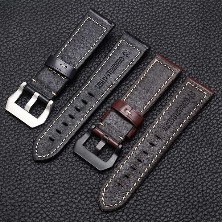 Black and brown genuine leather watch straps with stitching and metal buckles on a textured black surface