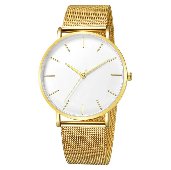 Minimalist gold wristwatch with white dial and gold mesh band on white background