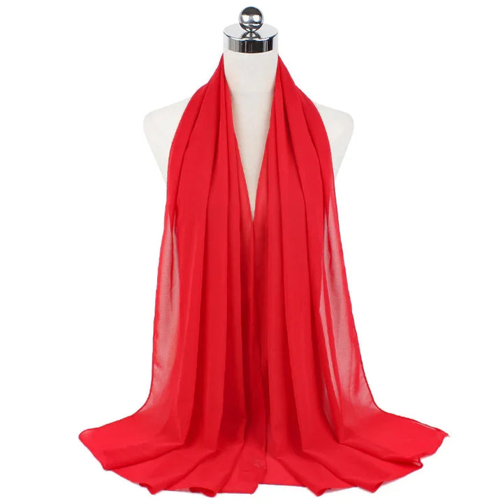Bright red lightweight chiffon scarf draped on white mannequin with chrome neck cap