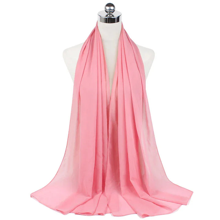 Light pink lightweight scarf draped on mannequin against white background
