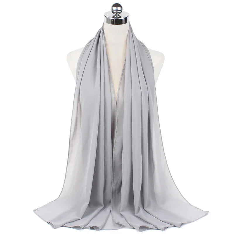 Light gray satin hijab displayed on dress form mannequin with smooth draping