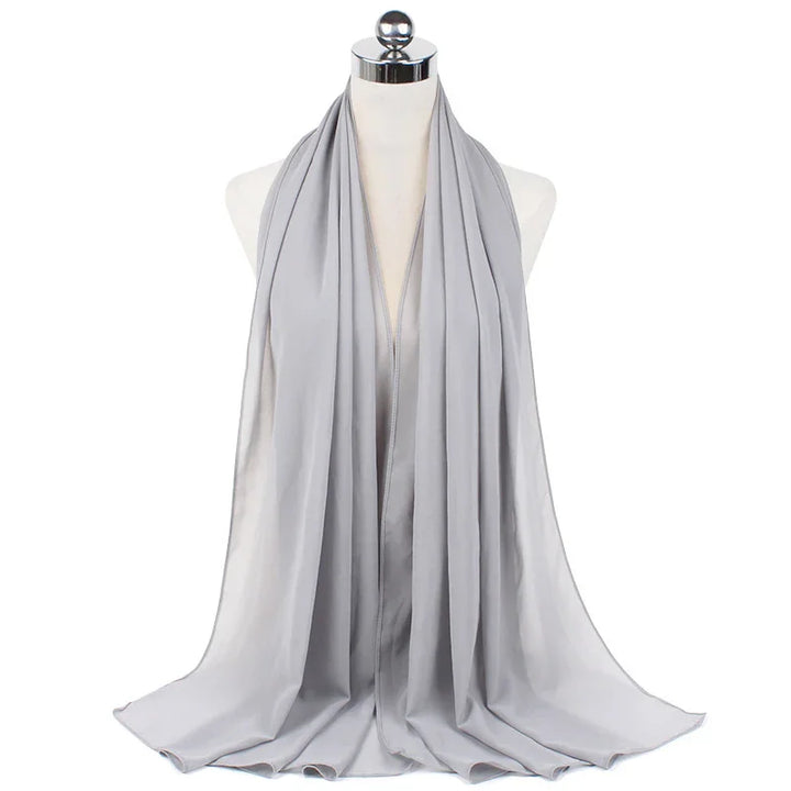 Light gray satin hijab displayed on dress form mannequin with smooth draping
