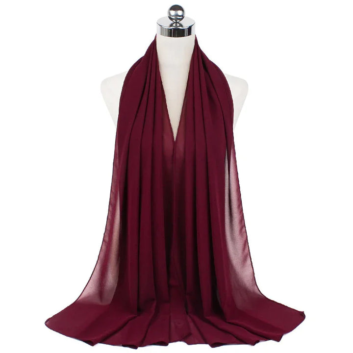 Burgundy chiffon scarf draped on white mannequin with metal neck stand