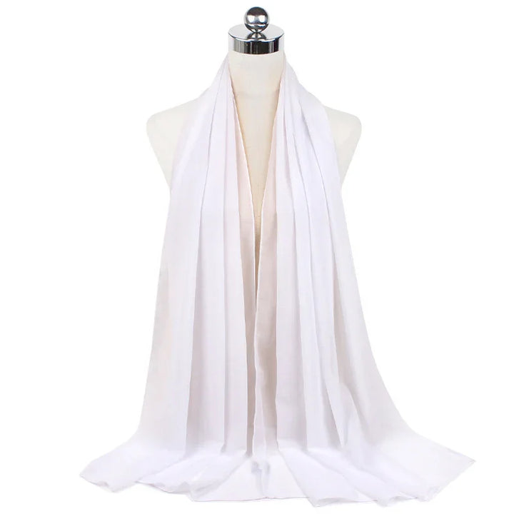 Long white lightweight scarf draped on dress form with chrome top against white background