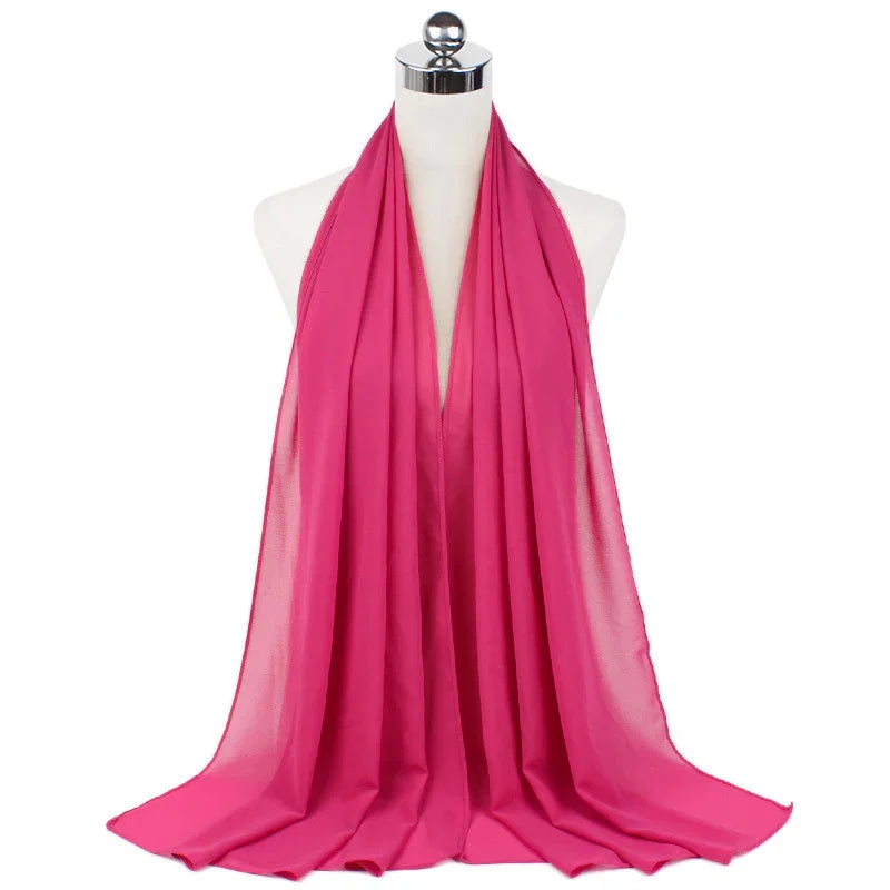 Bright pink chiffon scarf displayed on white mannequin with chrome stand