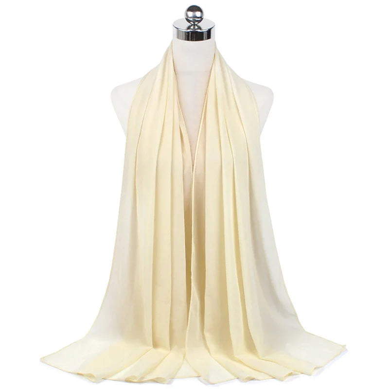 Cream-colored lightweight scarf displayed on mannequin with soft flowing fabric