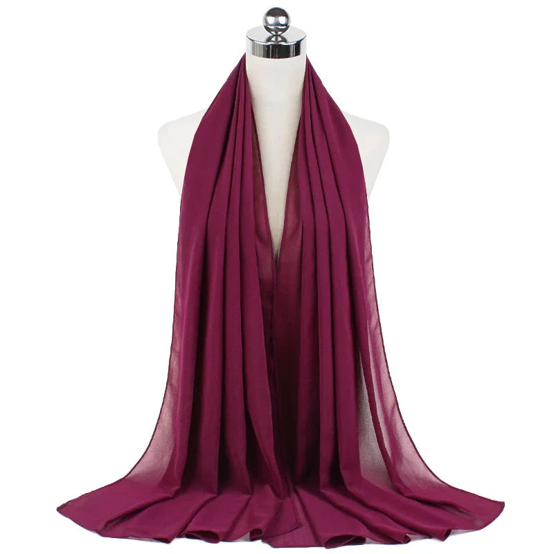 Deep magenta chiffon scarf draped on white mannequin bust with chrome top