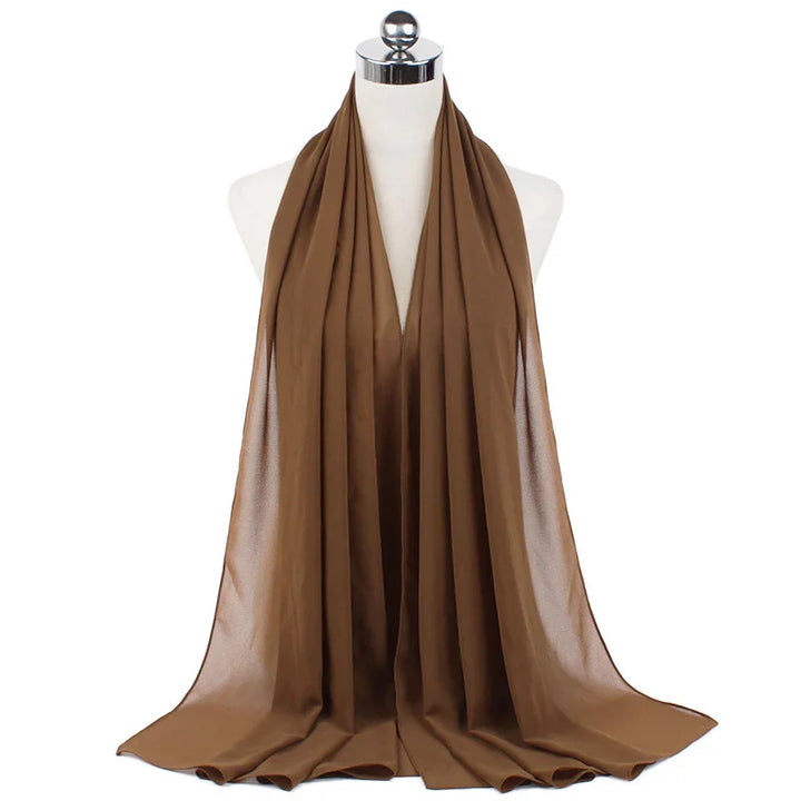 Brown satin scarf draped on white mannequin, smooth shiny fabric with elegant folds