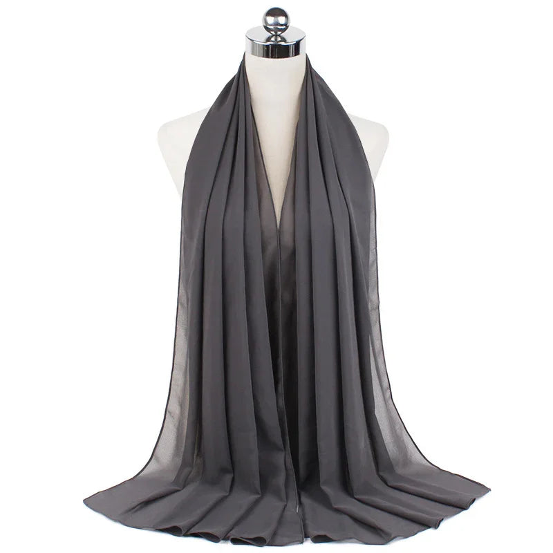 Dark gray satin hijab displayed on a mannequin against white background