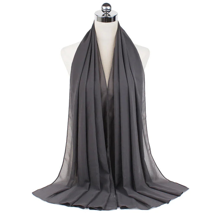 Dark gray satin hijab displayed on a mannequin against white background