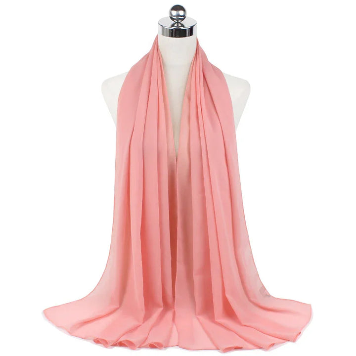 Soft pink chiffon scarf draped elegantly on white mannequin with silver top