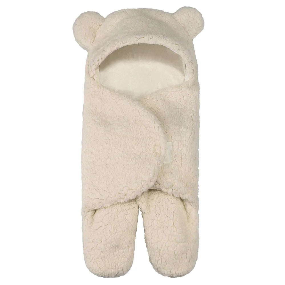 Soft cream-colored baby swaddle blanket with hood featuring bear ears and foot pockets