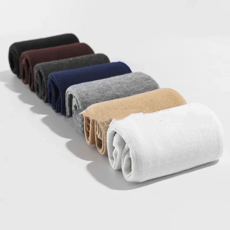 Rolled cotton socks in black, brown, dark gray, navy, gray, beige, and white on a white background