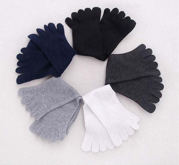 Five pairs of toe socks in black, navy blue, dark gray, light gray, and white arranged in a circle