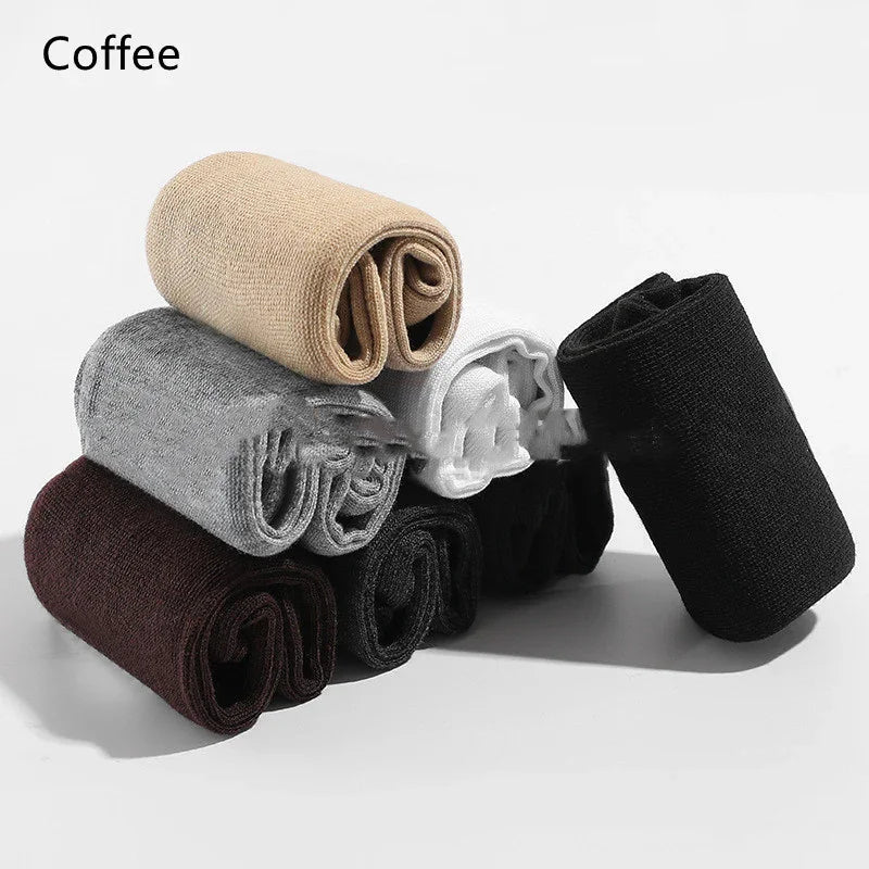 Stack of rolled cotton socks in coffee, gray, white, black, and brown on white background
