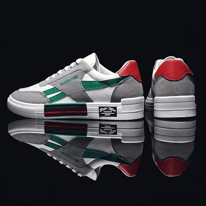 grey and white sneakers with green stripes and red heel detail on reflective black surface