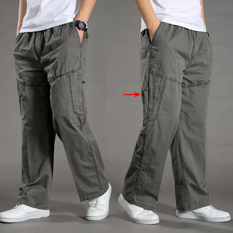 Men's casual loose-fit gray cargo pants with multiple pockets and white sneakers
