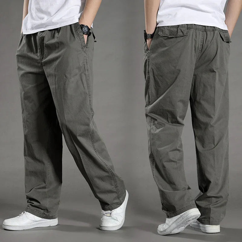 Men's casual loose-fit gray cotton pants paired with white sneakers and a white t-shirt