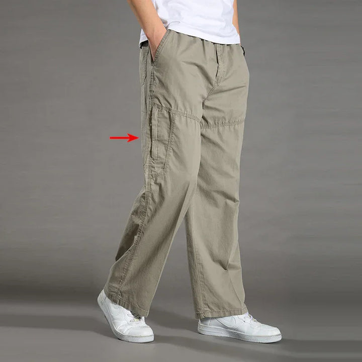 Casual khaki cargo pants with loose fit and side pockets worn with white sneakers and white T-shirt