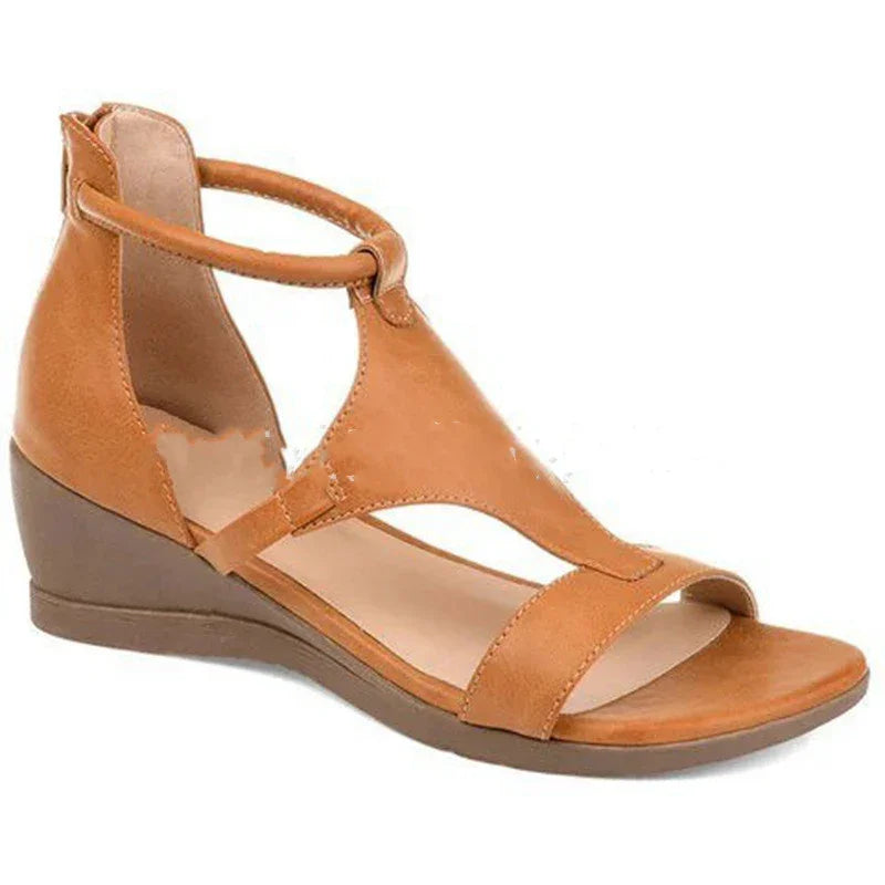 Tan brown wedge sandal with ankle strap and open toe design against white background