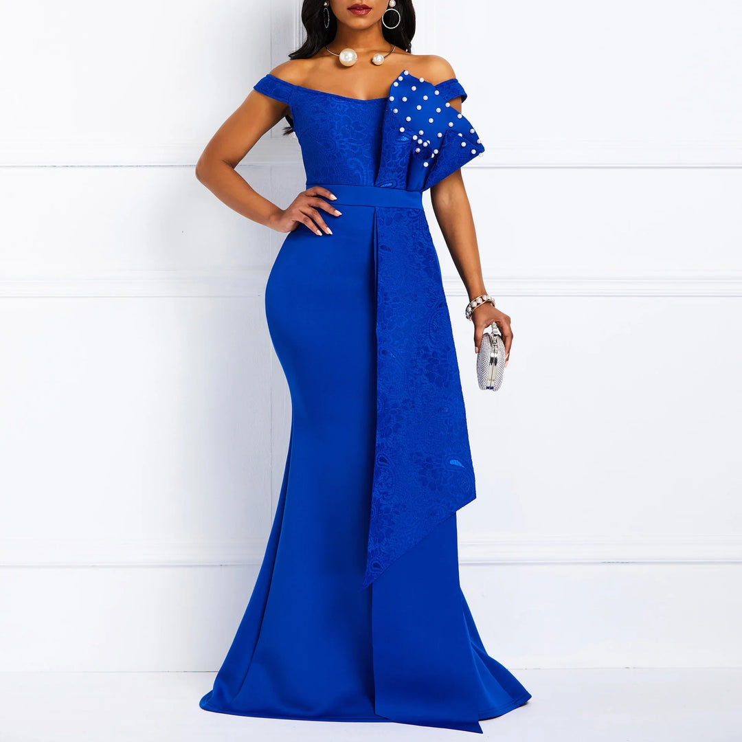 Elegant woman in royal blue off-shoulder evening gown with pearl-embellished bow detail