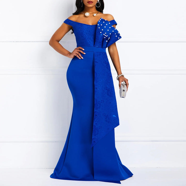 Elegant woman in royal blue off-shoulder evening gown with pearl-embellished bow detail
