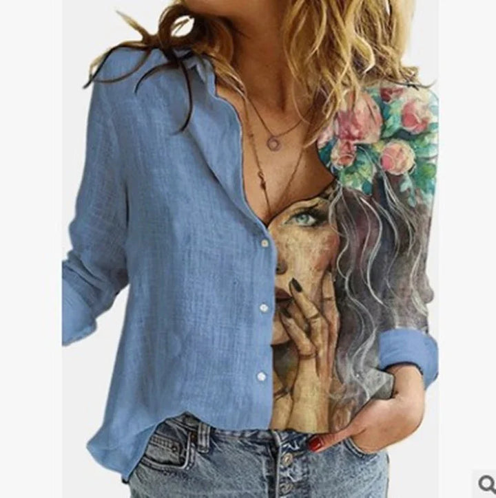 Woman wearing blue button-up shirt with artistic print of a face and floral design on one side, paired with jeans