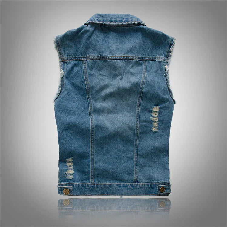 Back view of sleeveless distressed blue denim vest with frayed armholes on grey background