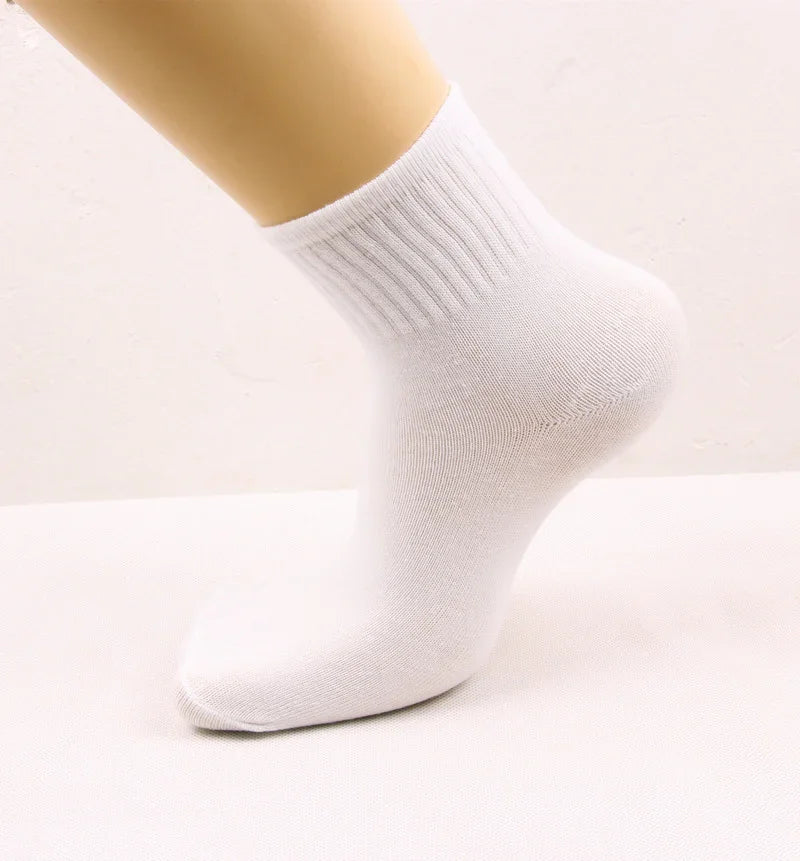 White ribbed ankle sock on beige mannequin foot against light background