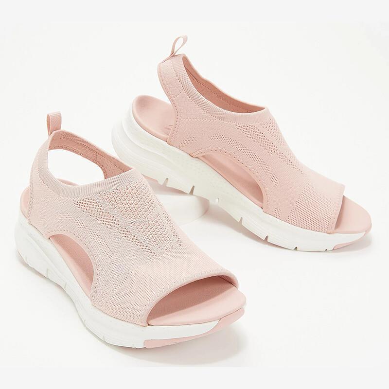 Light pink knitted open-toe sandals with white cushioned soles and ankle straps