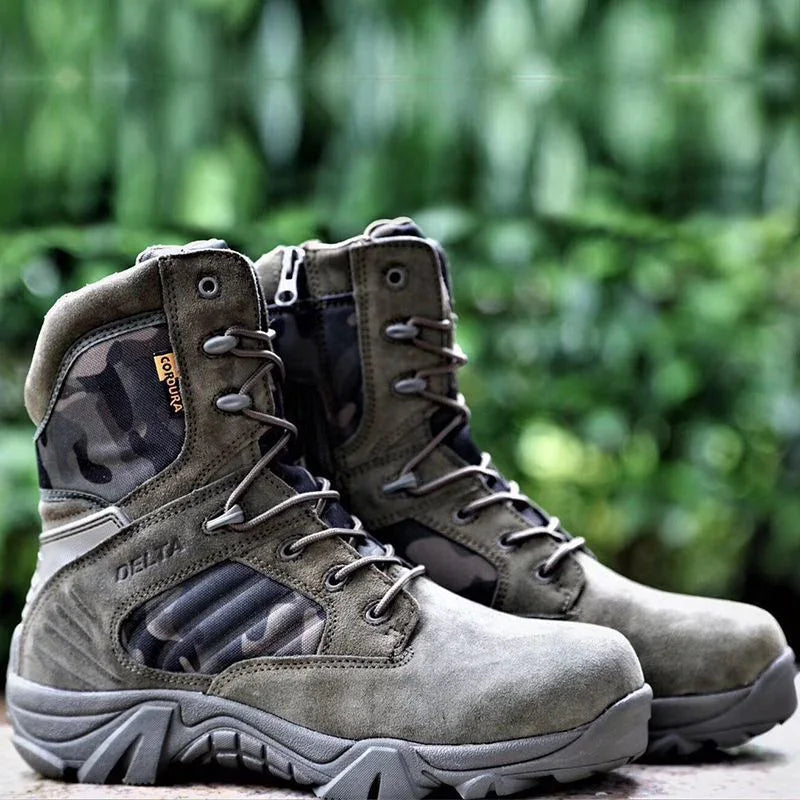 Pair of olive green tactical boots with cordura fabric and camouflage panels on a blurred green background