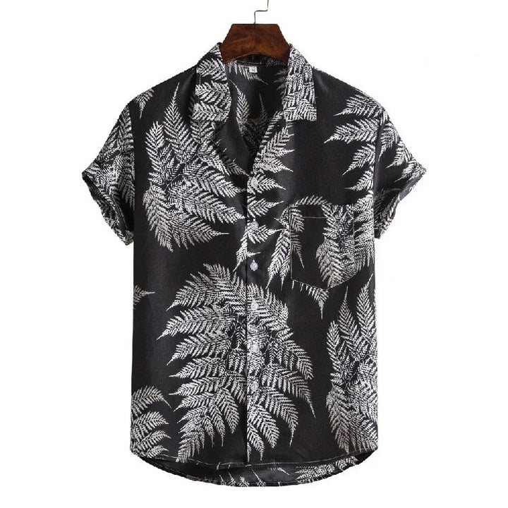 Black short-sleeve button-up shirt with white fern leaf print and chest pocket on wooden hanger