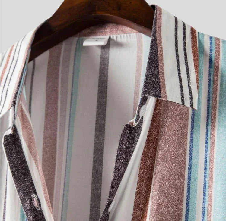 Close-up of striped shirt with collar on wooden hanger, featuring multicolor vertical stripes