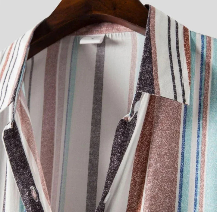 Close-up of striped shirt with collar on wooden hanger, featuring multicolor vertical stripes