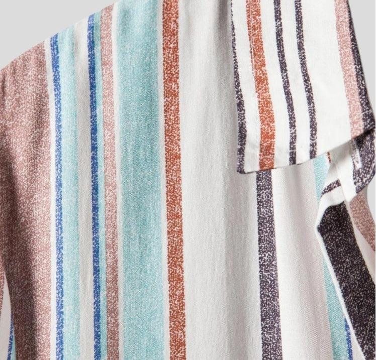 Close-up of multicolored striped fabric with textured vertical stripes in blue, teal, brown, and white